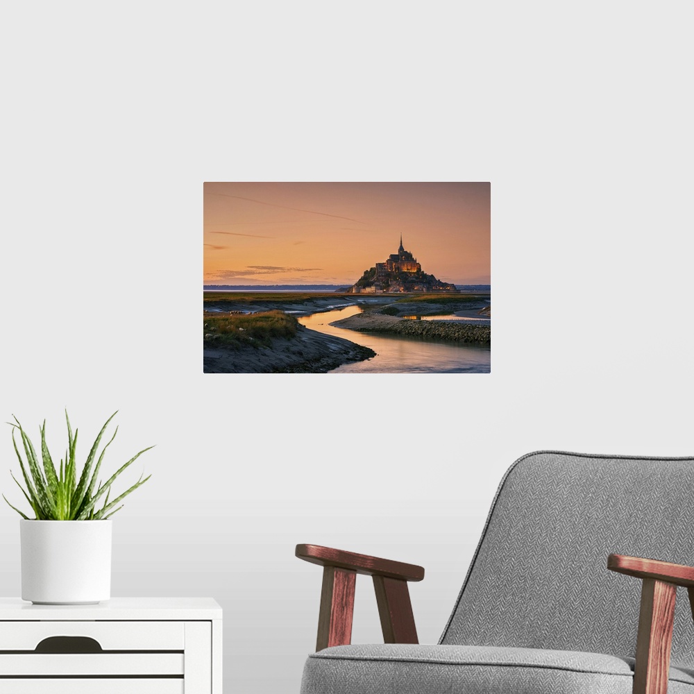 A modern room featuring Warm landscape photograph of rivers leading to a castle on top of a hill at sunset.