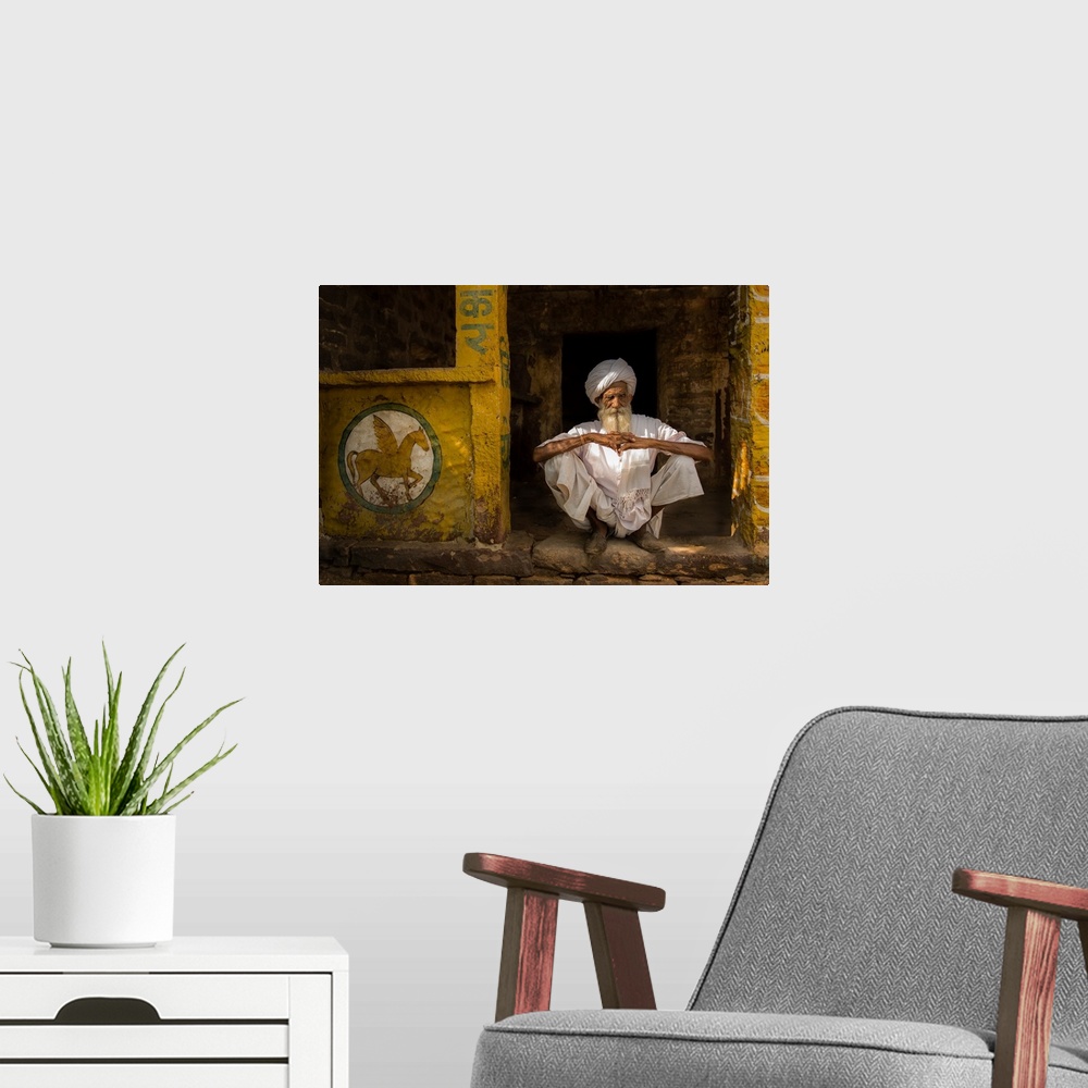 A modern room featuring A portrait of a man sitting in a yellow doorway with a painting of a pegasus painted on the wall ...