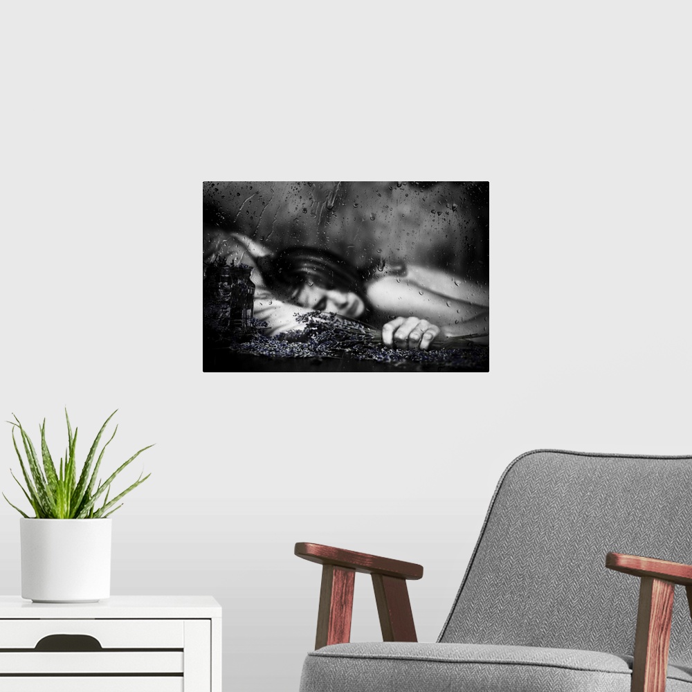 A modern room featuring Black and white image of a woman laying down with falling raindrops.