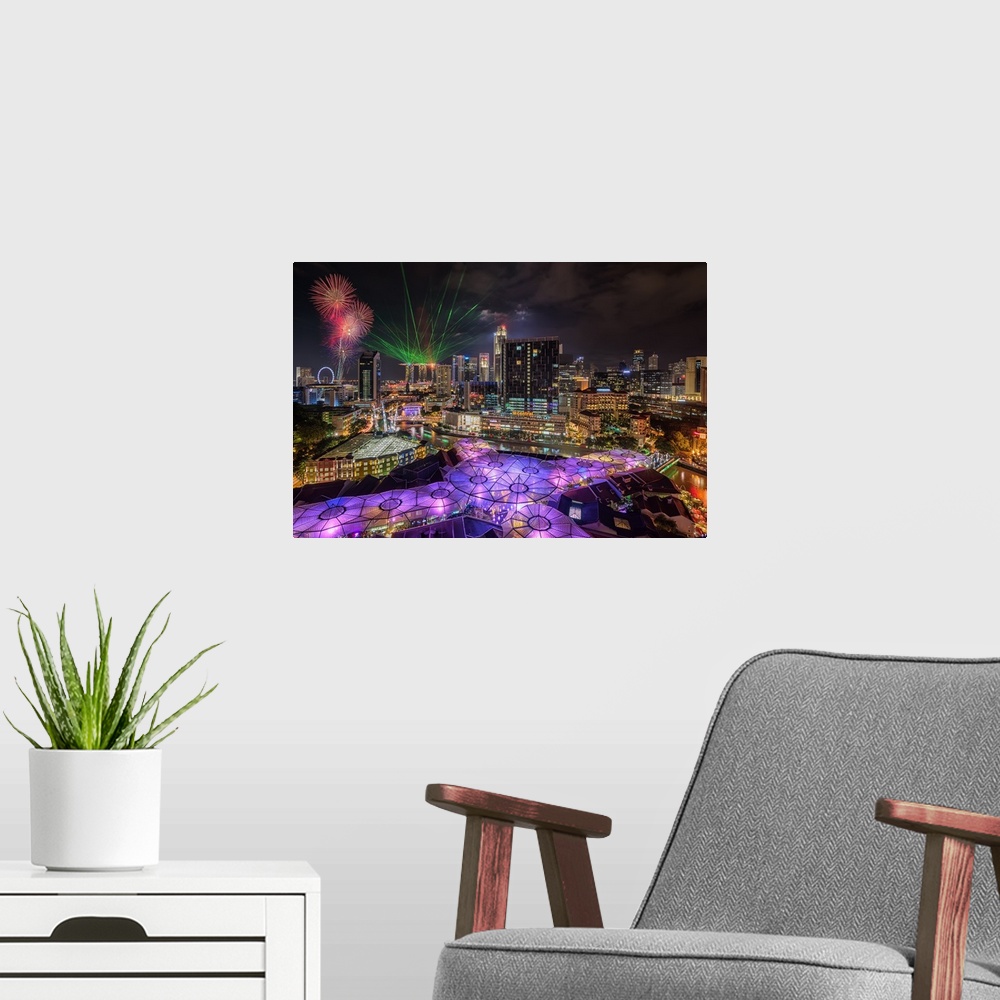 A modern room featuring Laser lights and fireworks display in Singapore at night.
