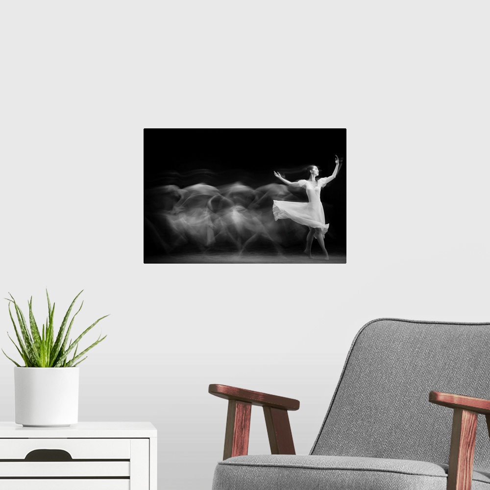 A modern room featuring A black and white multi-exposure photograph of a dancer wearing a white dress.