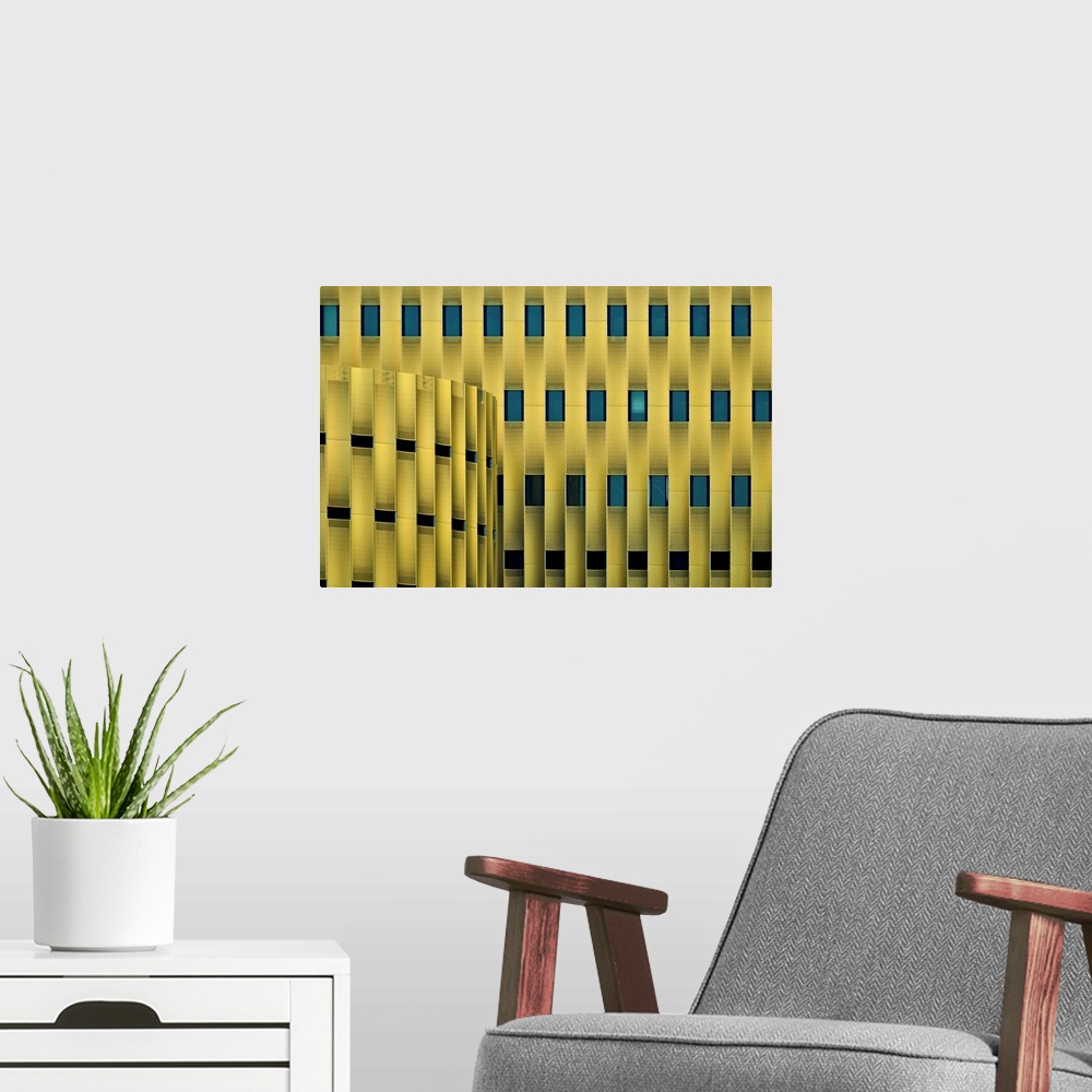 A modern room featuring Facade of a yellow building with repeating blue windows, forming an abstract pattern.