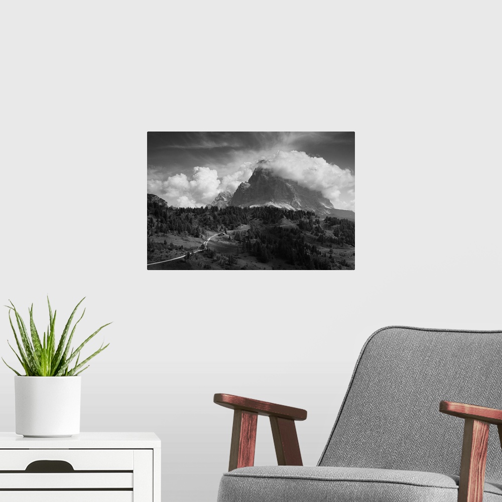 A modern room featuring A giant cloud passes over a mountaintop, resembling billowing smoke.