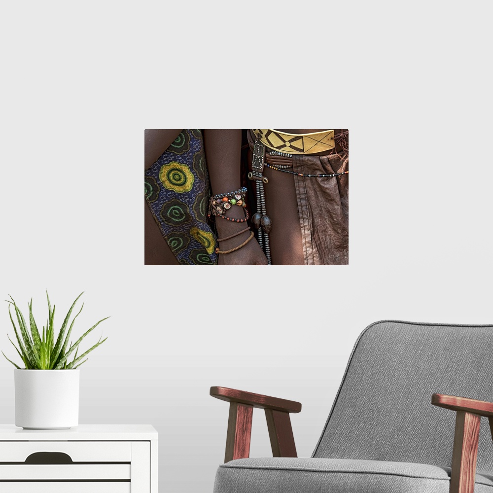 A modern room featuring Photograph of the jewelry worn by tribes people.