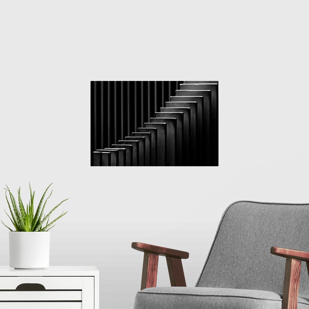 A modern room featuring Abstract black and white photograph with leading lines made up of rectangular slits.