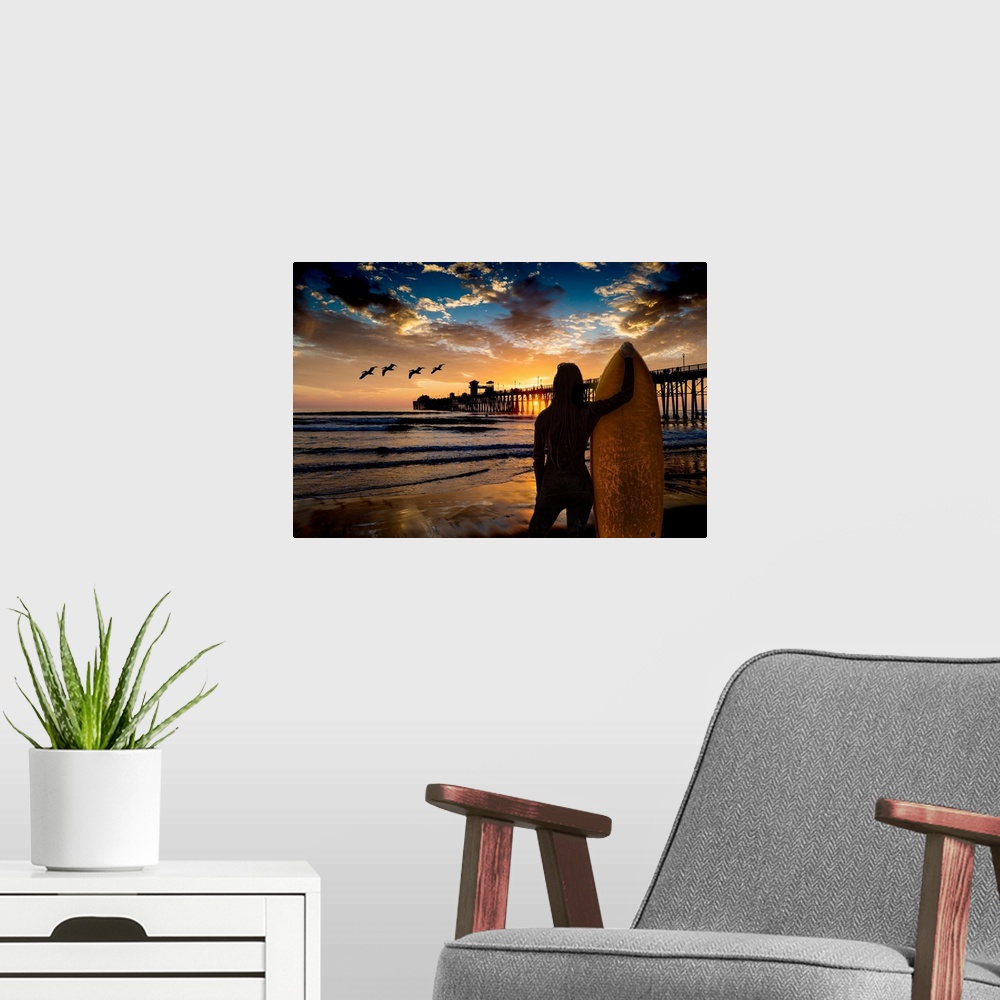 A modern room featuring A female surfer watches the last waves near the Oceanside Pier, Oceanside, California, USA