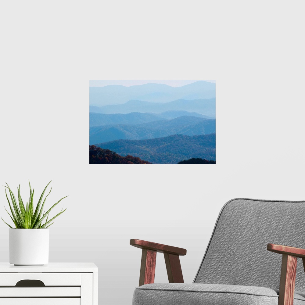 A modern room featuring A bluish haze over the Blue Ridge Mountains at sunset.
