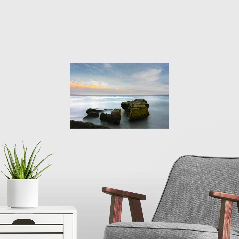 A modern room featuring A long exposure seascape made along a rocky beach in Santa Cruz, California, United States of Ame...