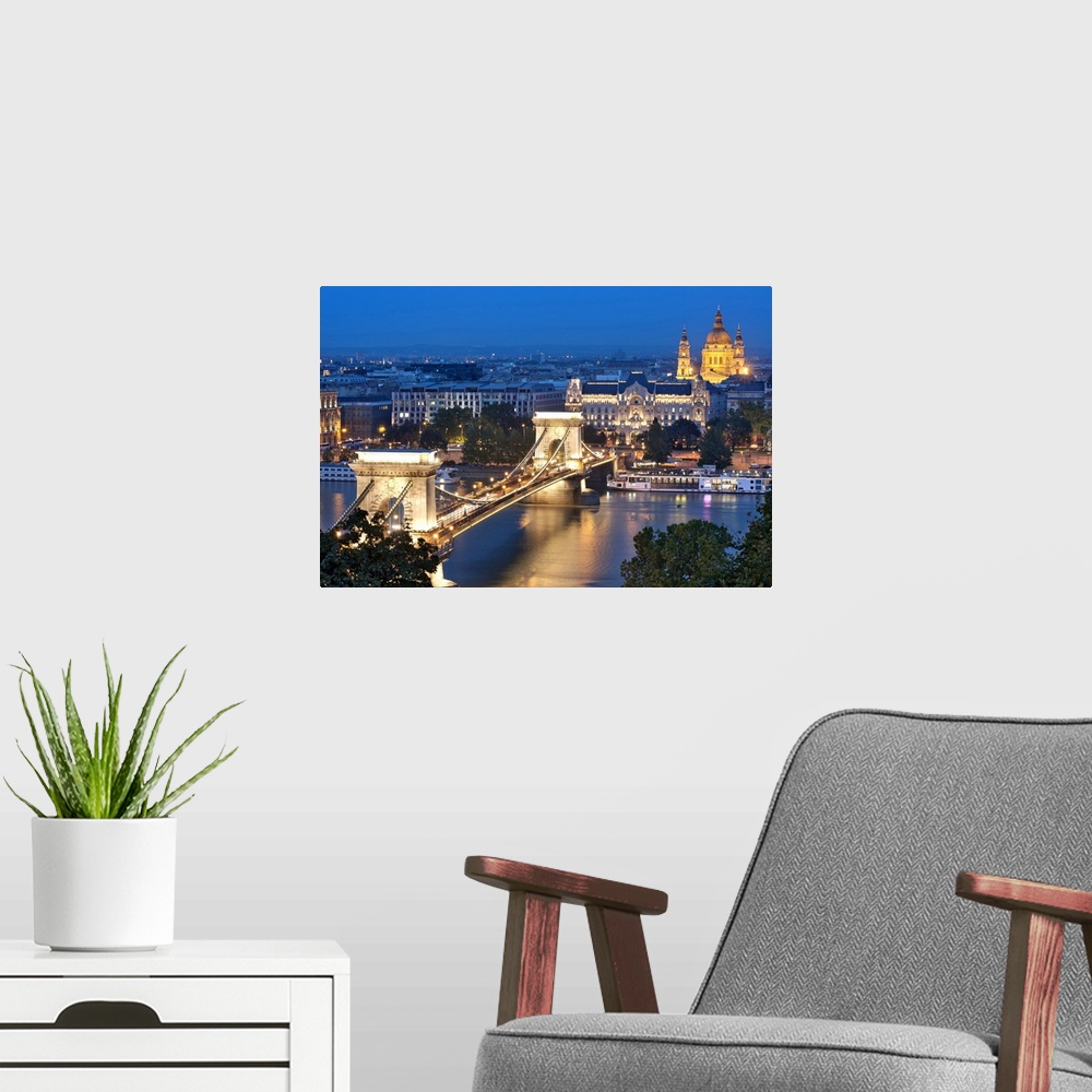 A modern room featuring A night view of Szechenyi Chain Bridge over the Danube River in Budapest.