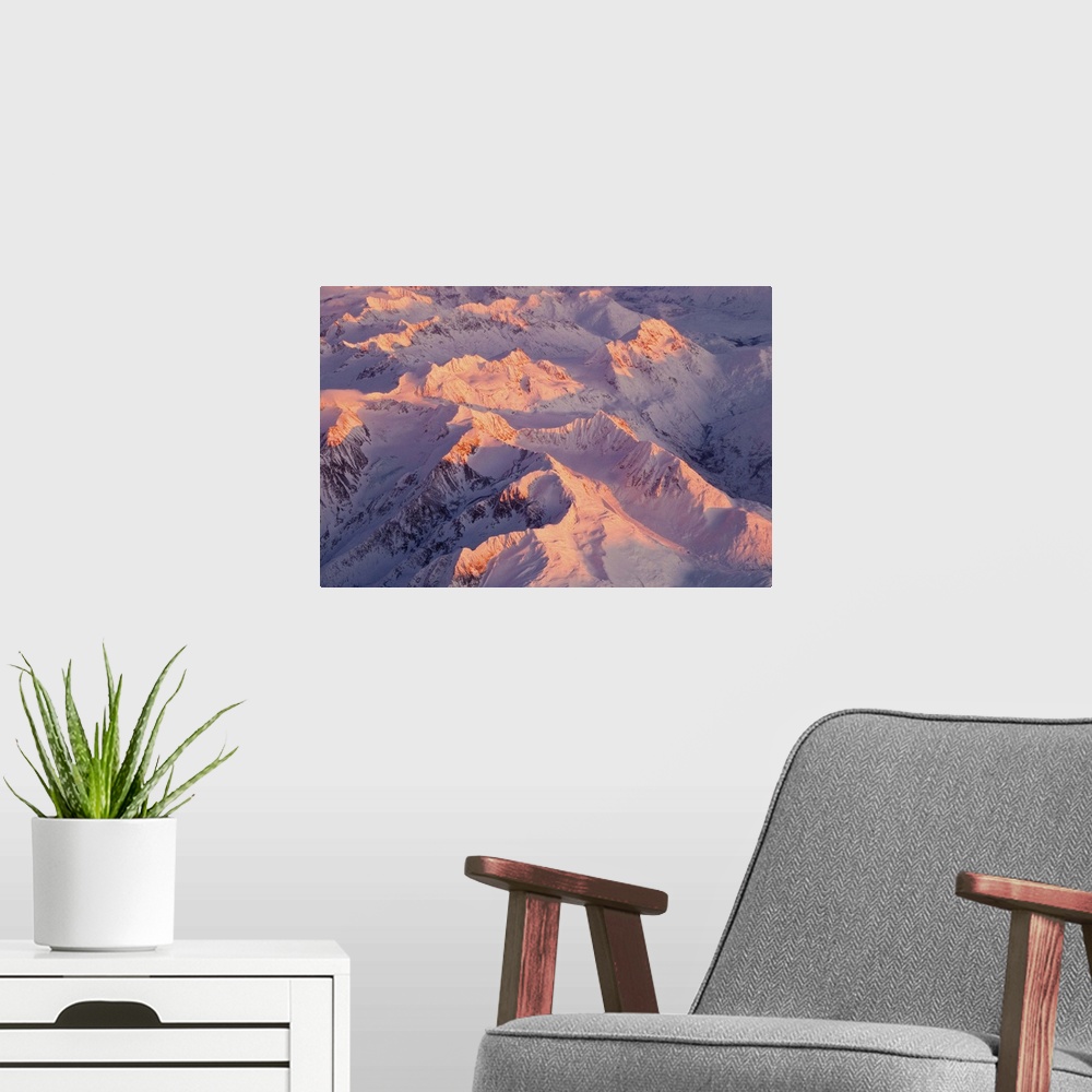 A modern room featuring Aerial view of the Chugach Mountain range with sunrise alpenglow hitting the peaks during Winter ...