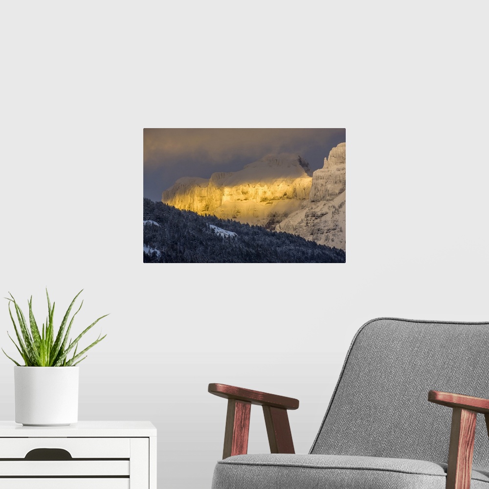 A modern room featuring Coated with snow and illuminated with the warm light of sunset, Amphitheater Mountain glows with ...
