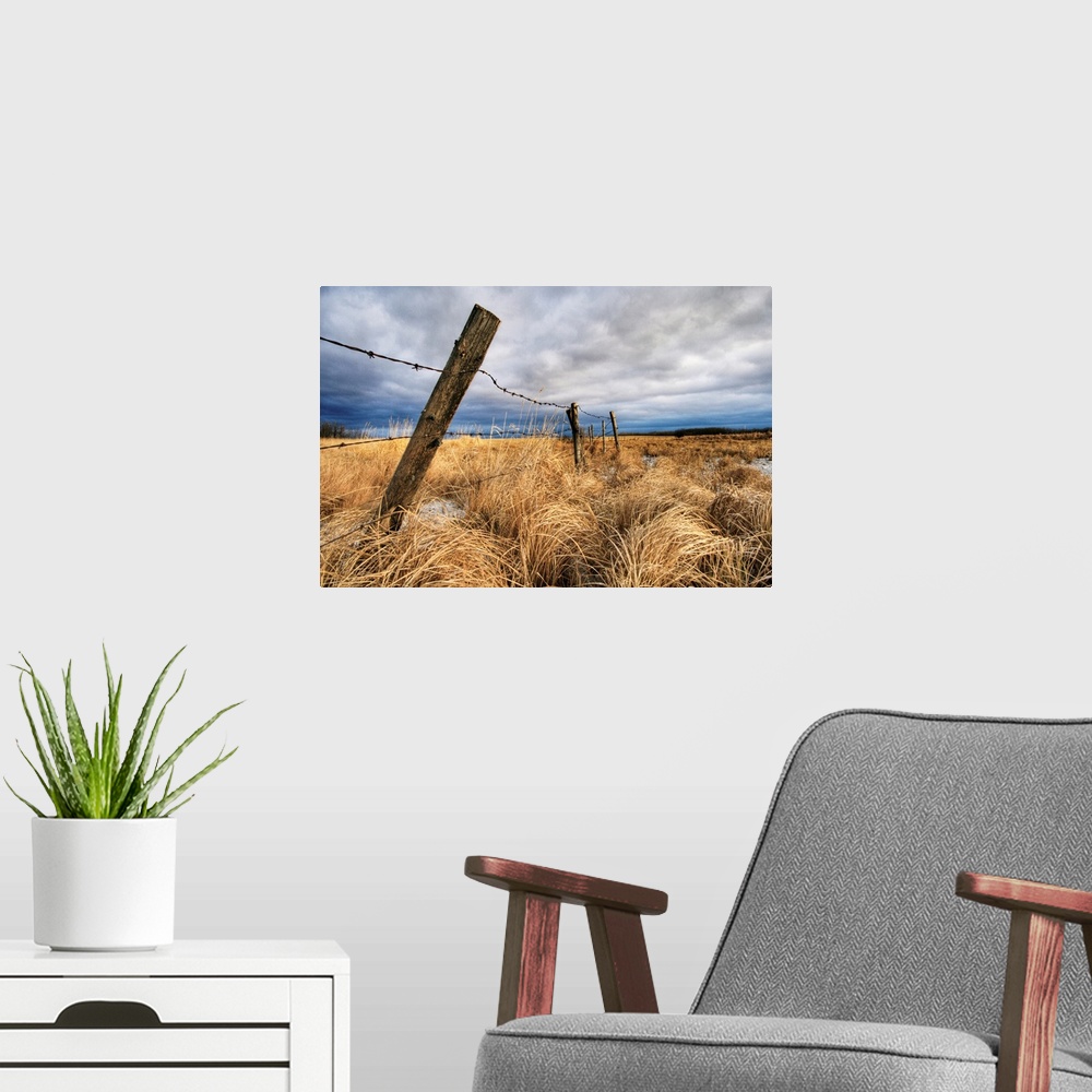 A modern room featuring Barbed Wire Fence Posts With Dark Sky In Background, Alberta, Canada