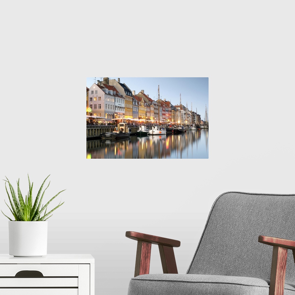 A modern room featuring Boats and townhouses along the Nyhavn canal in Copenhagen.