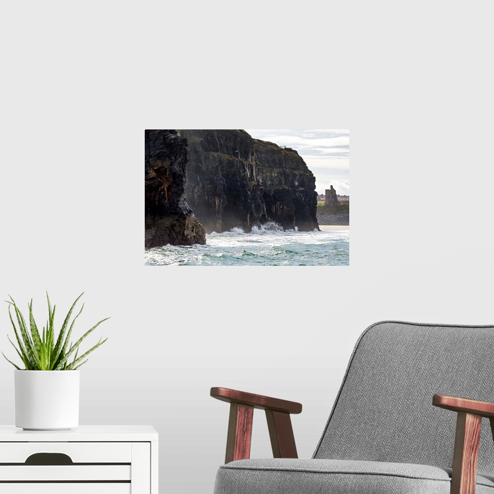 A modern room featuring Dark straight cliffs with waves crashing into the rock with ruined castle turret in background, B...