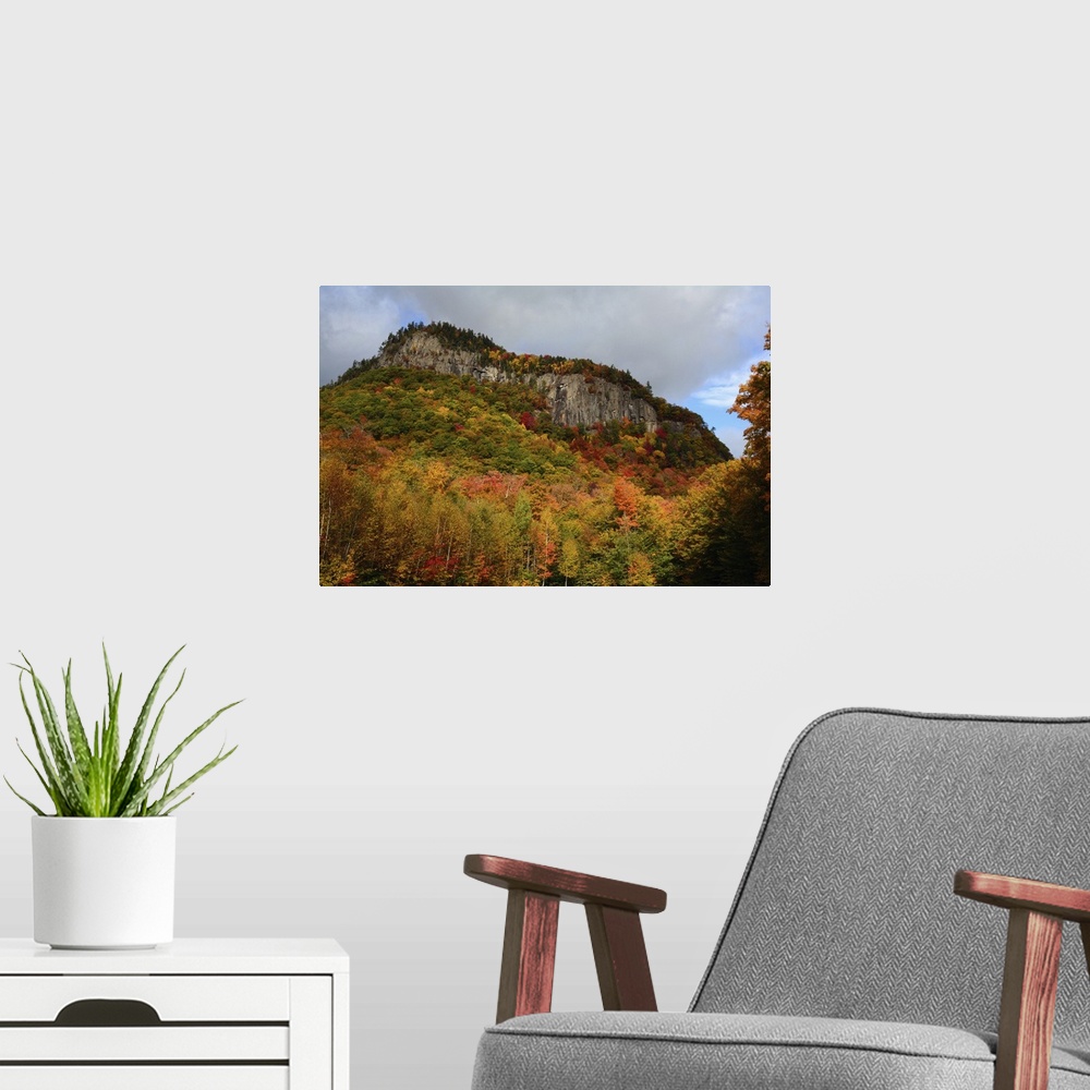 A modern room featuring Scenic view of fall foliage and exposed rock on a hillside in the White Mountains, New Hampshire....