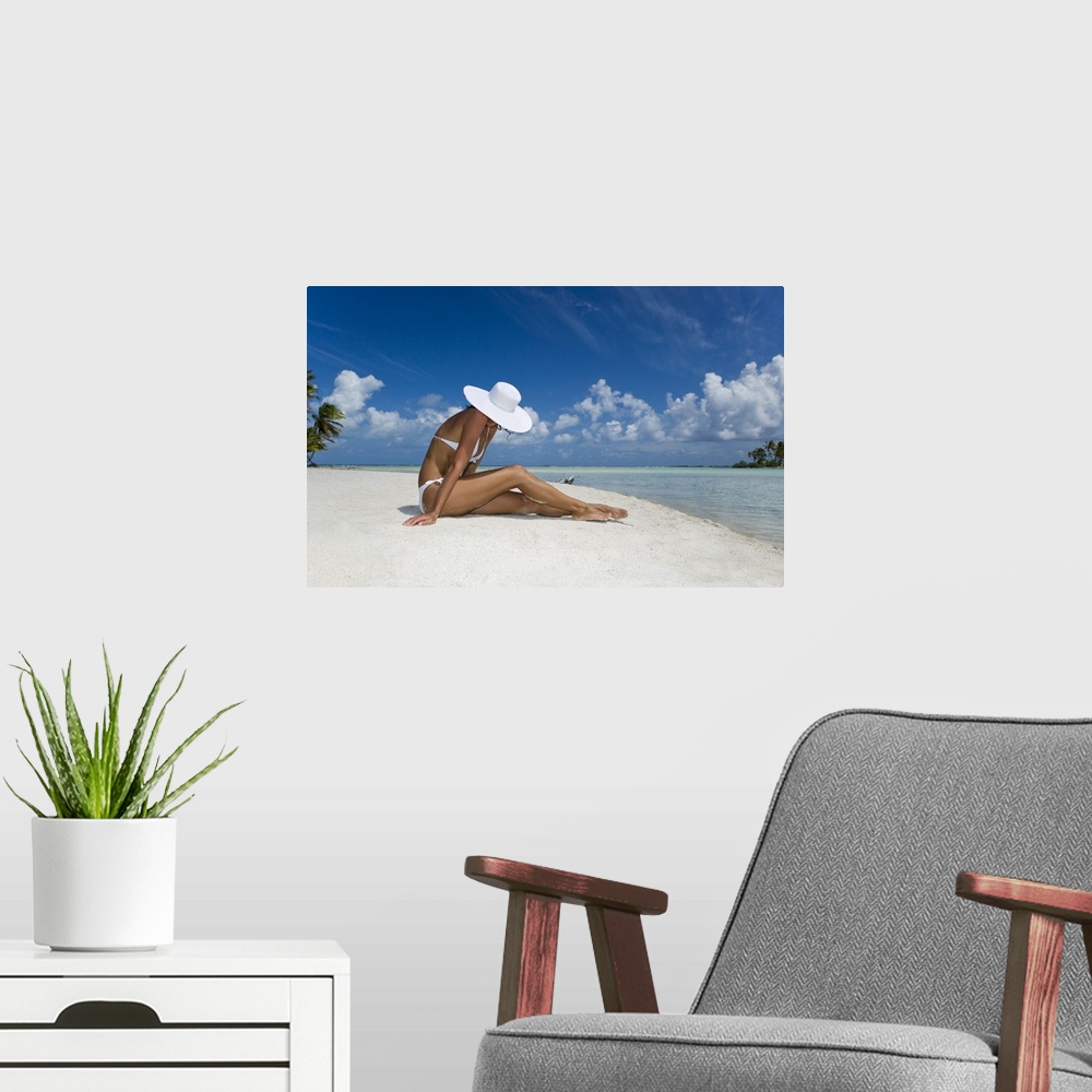 A modern room featuring French Polynesia, Tuamotu Islands, Rangiroa Atoll, Woman Sitting On White Sand Beach