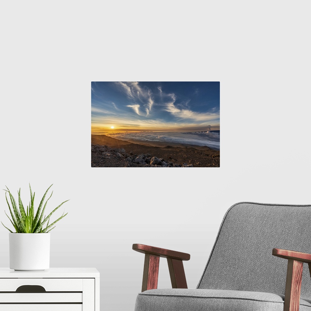 A modern room featuring Spectacular scene of the golden twilight above the clouds at Mauna Kea with view of the smoke fro...