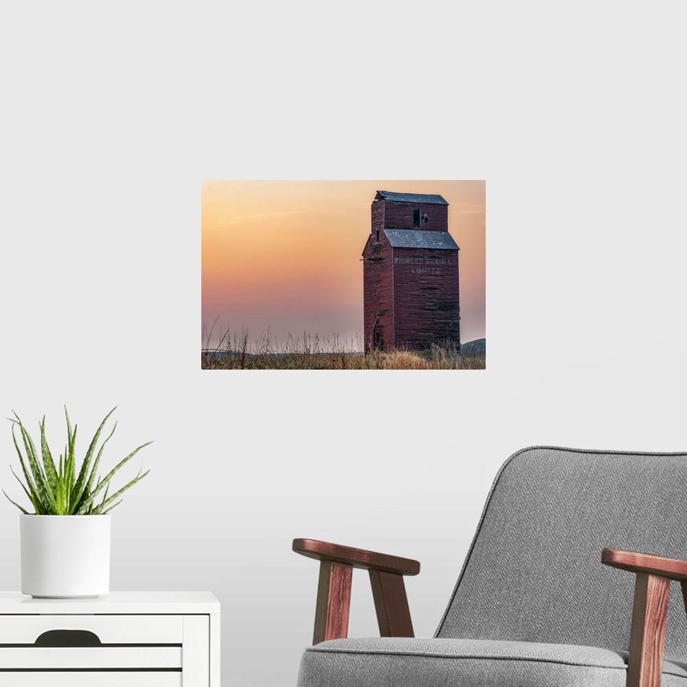 A modern room featuring Abandoned and weathered grain elevator at sunset on the Canadian Prairies; Val Marie, Saskatchewa...