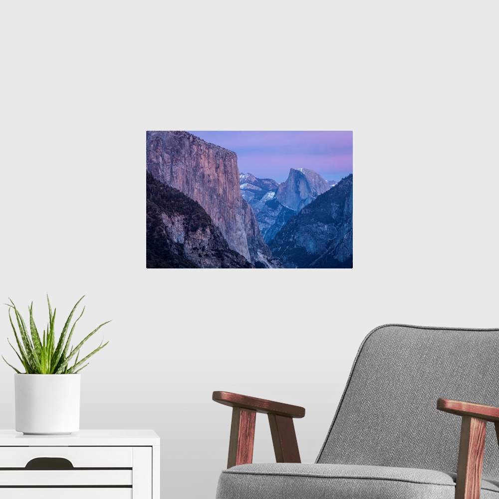 A modern room featuring Shades of pink and lavender are reflected on El Capitan, Half Dome and winter clouds at dusk in Y...