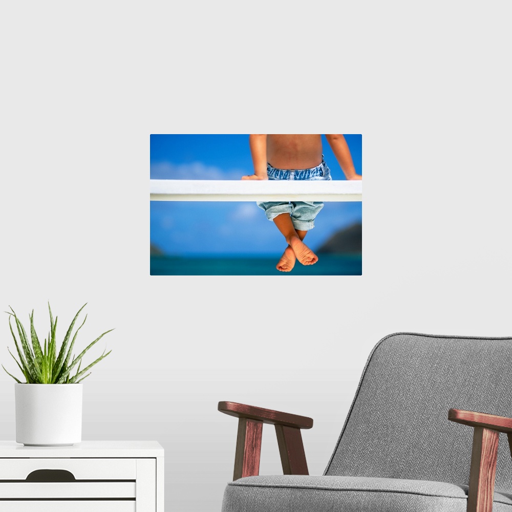 A modern room featuring Hawaii, Legs And Feet Of Young Boy Sitting On A Bench By The Ocean