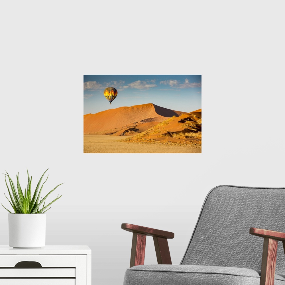 A modern room featuring Hot air balloon ride over the red sand dunes of Sossusvlei in Namibia; Sossusvlei, Hardap Region,...