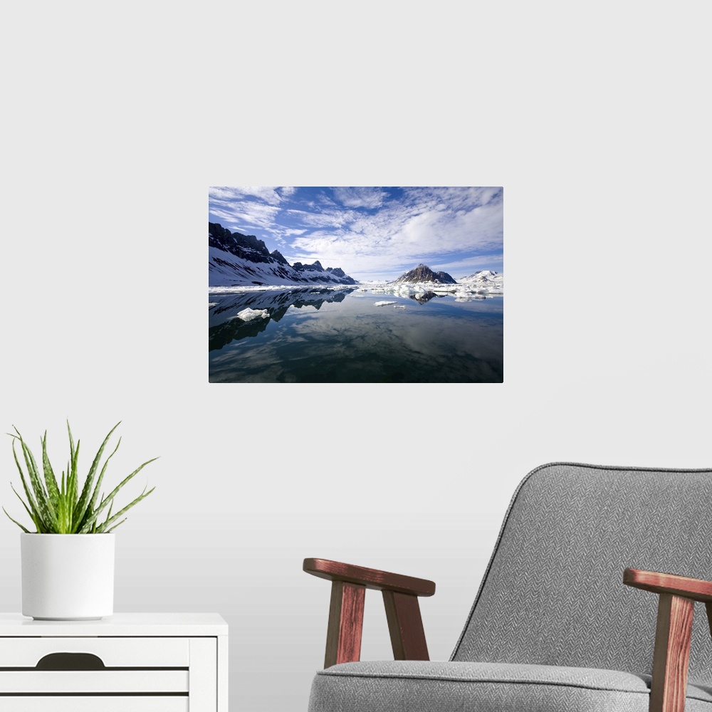 A modern room featuring Jagged coastal peaks casting reflections in cold Arctic waters.
