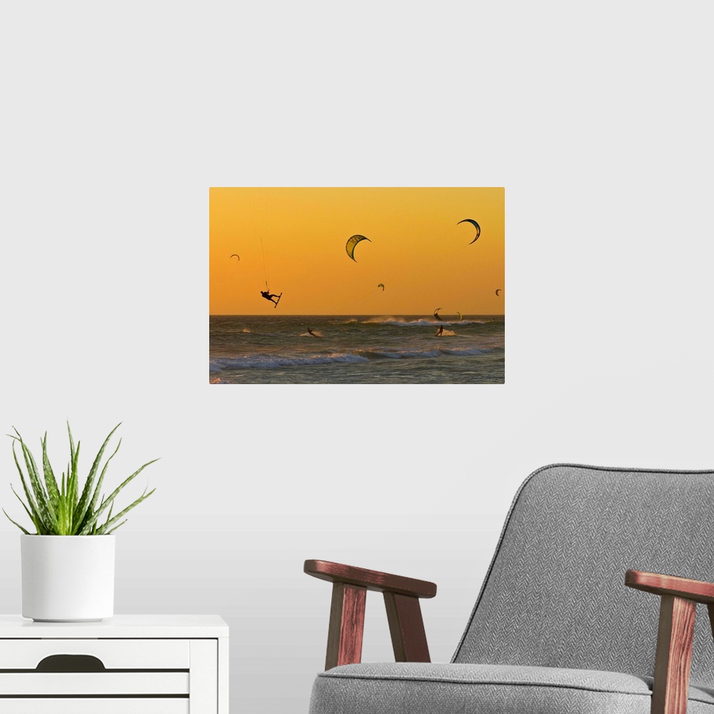 A modern room featuring Kite surfers at sunset.