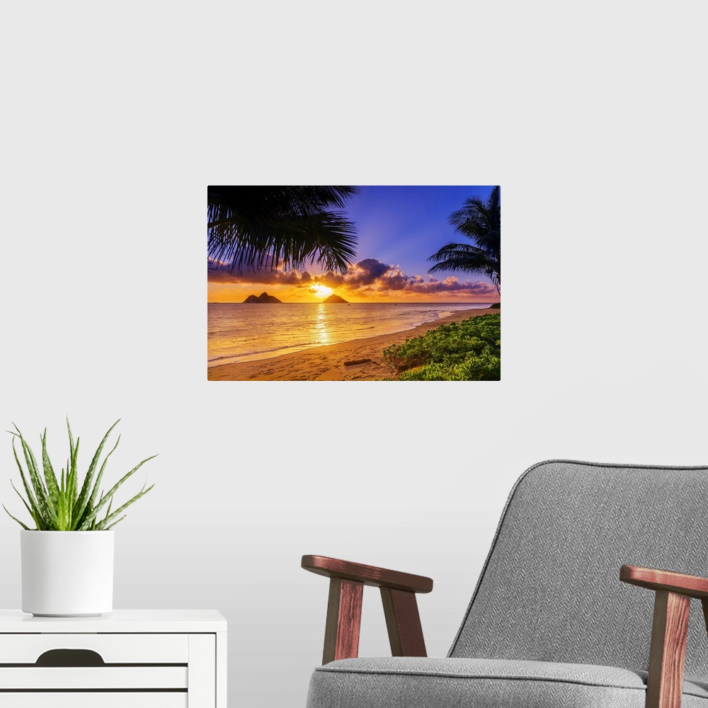 A modern room featuring Sunrise viewed from Lanikai Beach with a view of the Mokulua Islands off the coast; Oahu, Hawaii,...