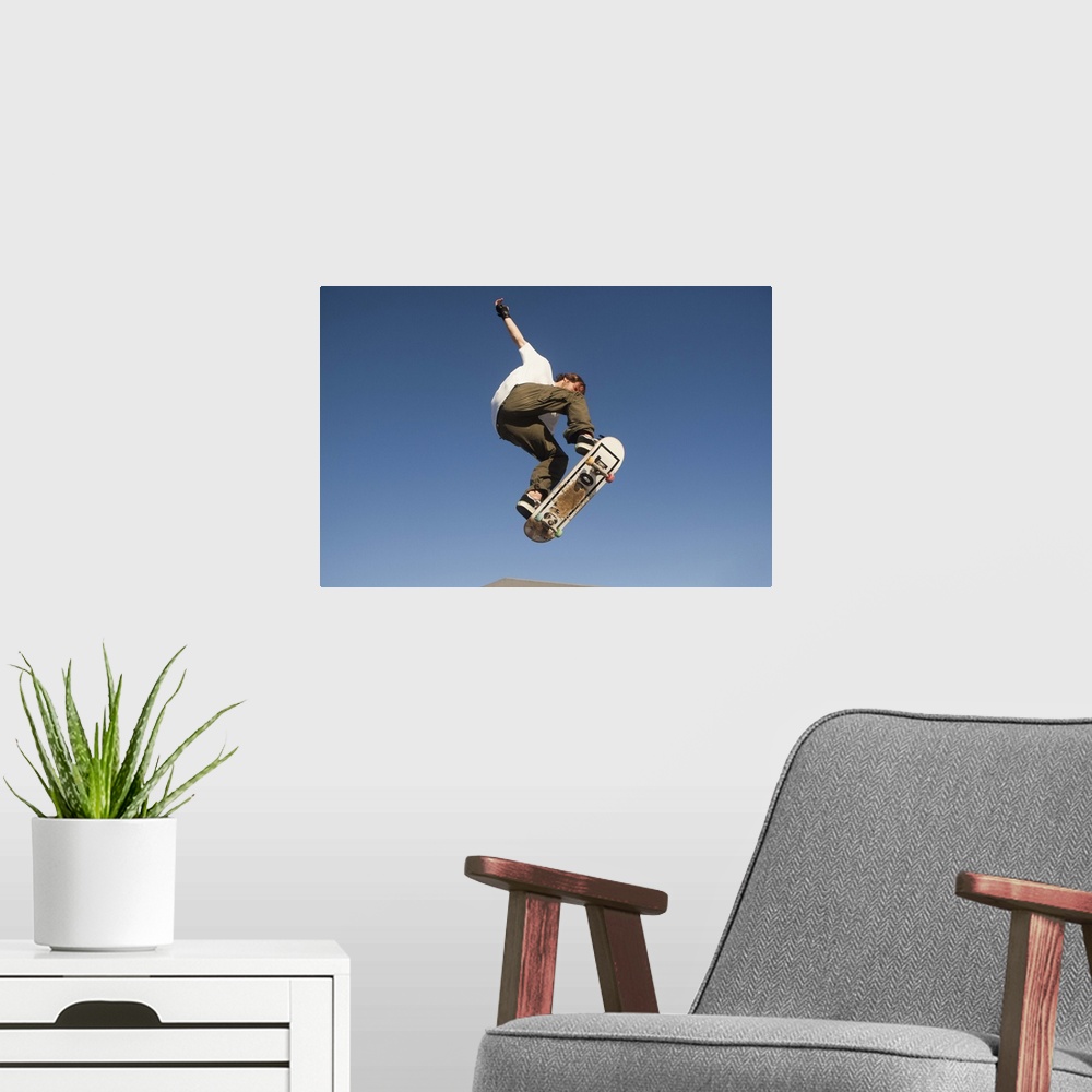 A modern room featuring Low Angle View Of Young Male Skateboarder
