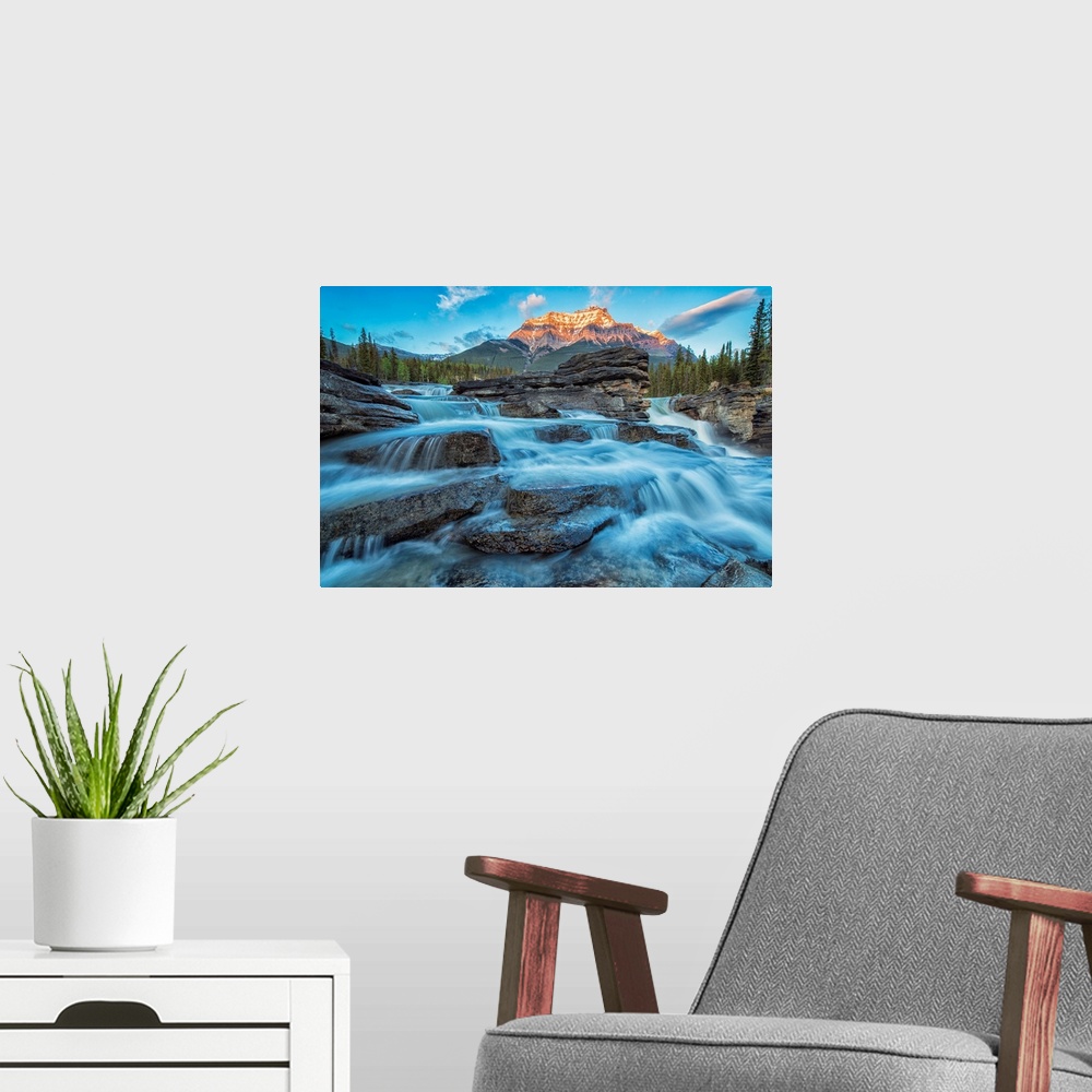 A modern room featuring Sunset lights up Mount Fryatt as the Athabasca River flows over Athabasca Falls in Jasper Nationa...