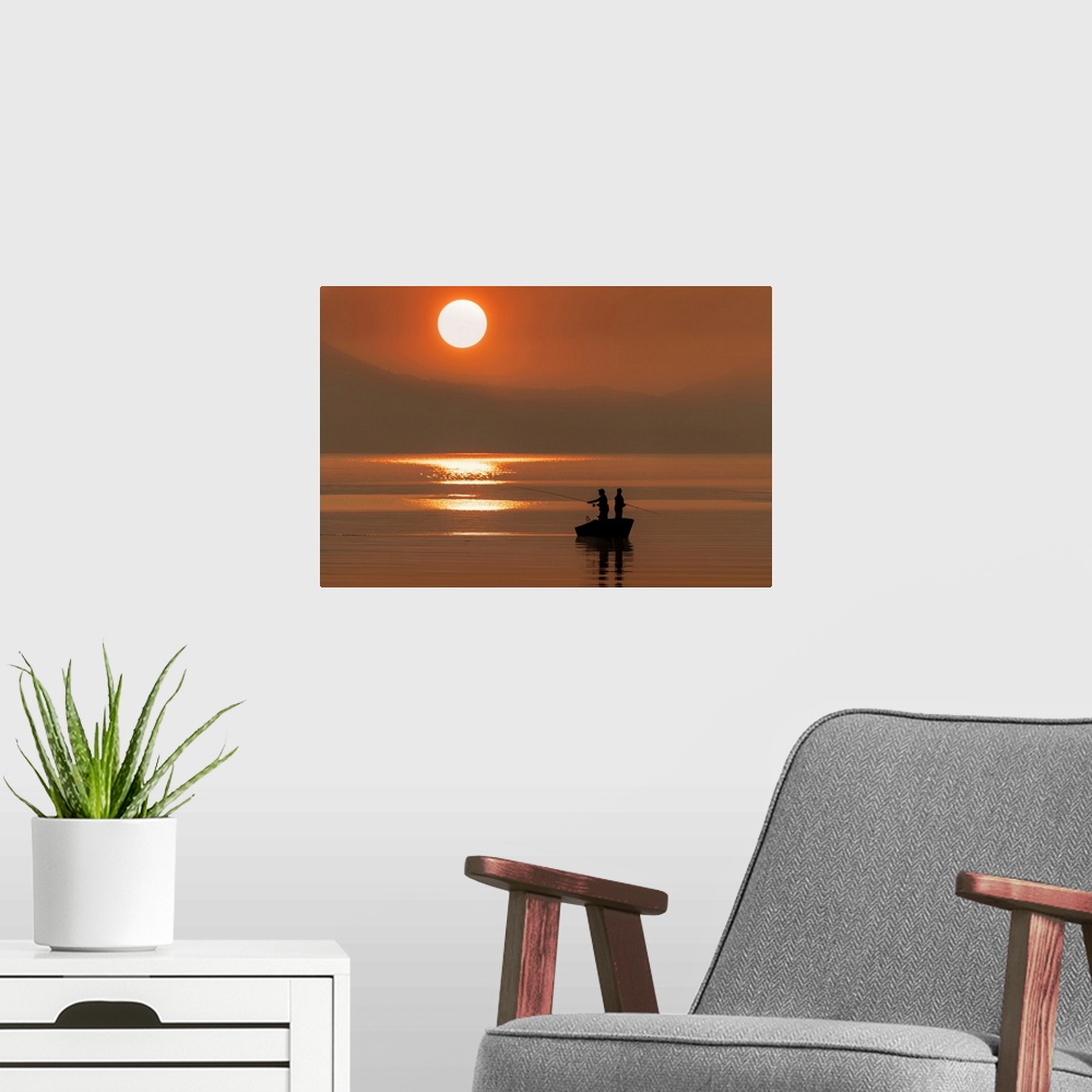 A modern room featuring Silhouetted anglers standing in a boat fishing for salmon at sunset; Juneau, Alaska, United State...