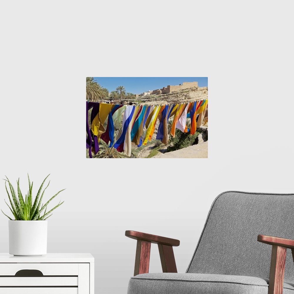 A modern room featuring Souvenir Scarves Flap In The Breeze Above The Canyon Near The Algerian Border; Mides, Tunisia, No...