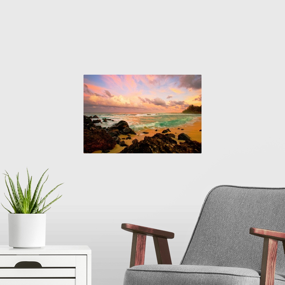 A modern room featuring Photograph taken over rocks that line a beach and looking out onto a sunset lit sky.