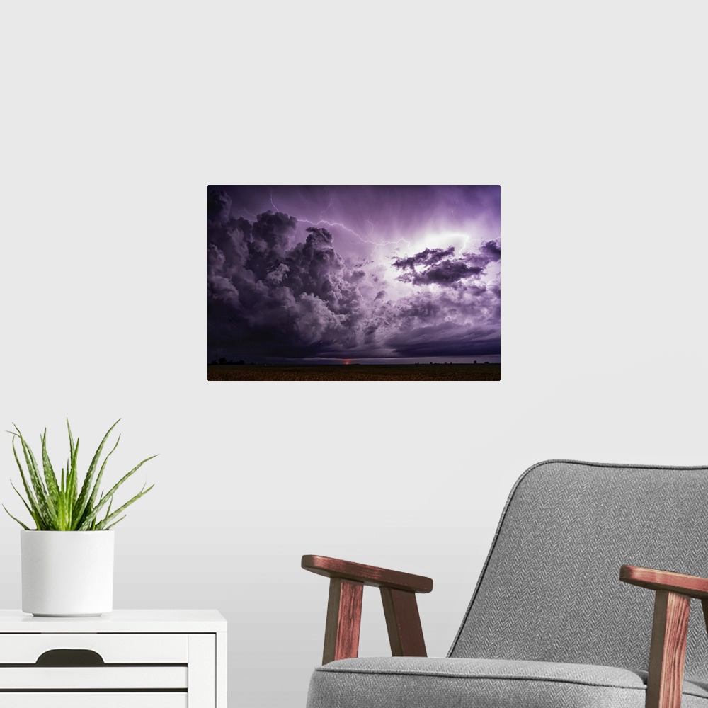 A modern room featuring Supercell thunderstorm clouds show off the power of mother nature. Massive clouds build and unlea...