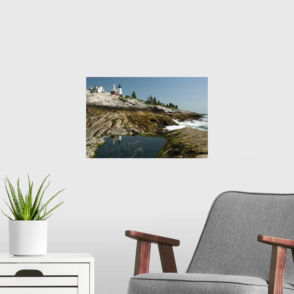 A modern room featuring The Pemaquid lighthouse and its reflection in a coastal tidal pool, Pemaquid Point, Maine.