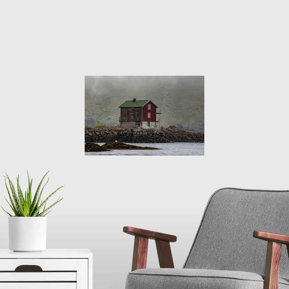 A modern room featuring Traditional fishing village house next to the shoreline in Lofoten, Lofoten, Arctic Circle, Norway