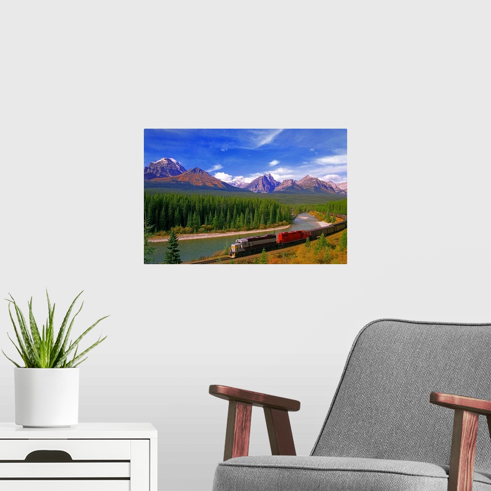 A modern room featuring Big canvas photo art of a train running through the Canadian countryside with forests surrounding...