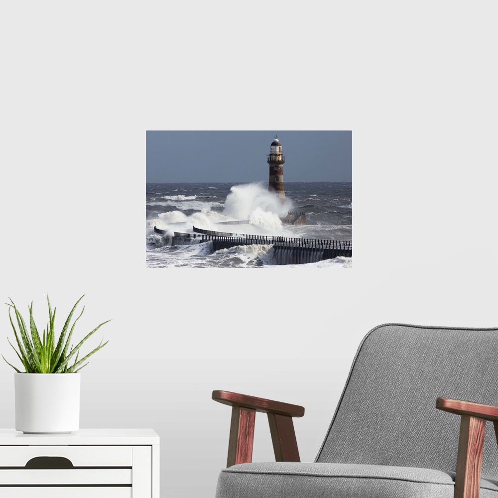 A modern room featuring Waves crashing into a lighthouse on the coast, Sunderland Tyne and Wear England