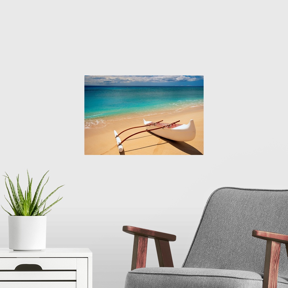A modern room featuring Horizontal canvas of a canoe sitting on a beach with crystal clear water washing ashore from the ...