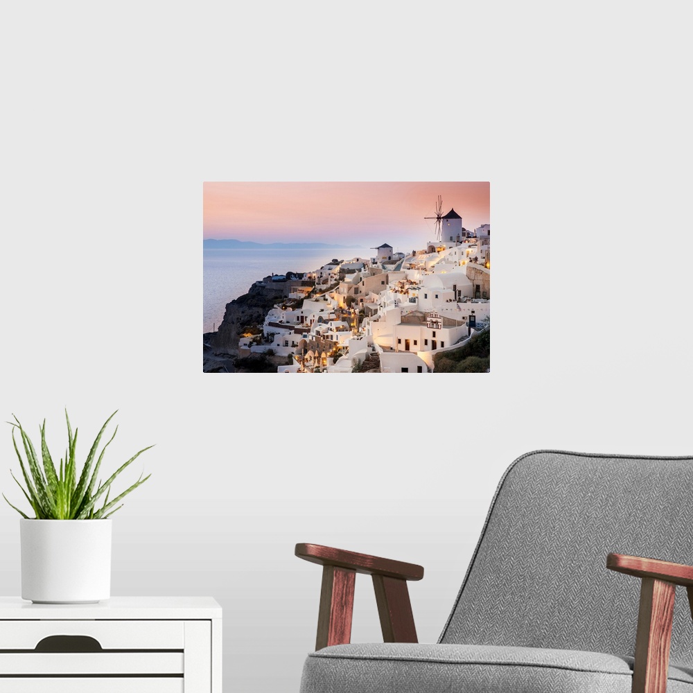A modern room featuring Whitewash buildings and windmill at dusk; Oia, Santorini, Greece