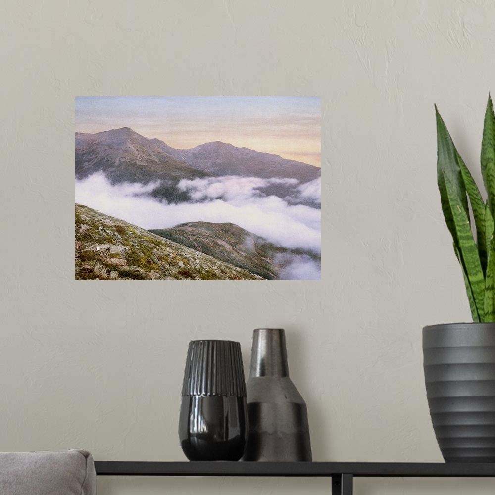 A modern room featuring Photograph of mountains peeking through fog.