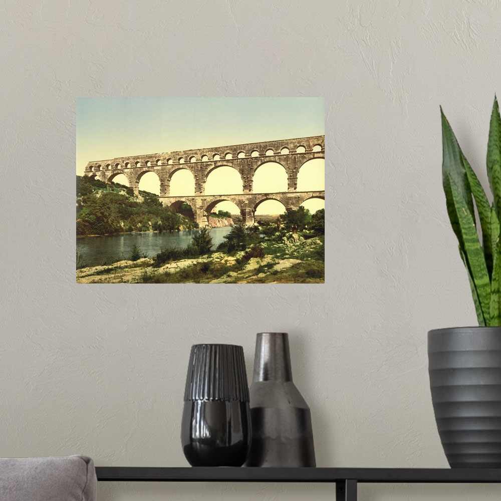 A modern room featuring Hand colored photograph of roman bridge over the gardon, constructed by Agrippa, Nimes, France.