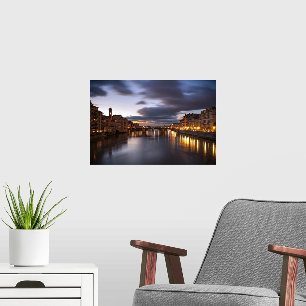 A modern room featuring Arno, city with lights reflecting from the bridge