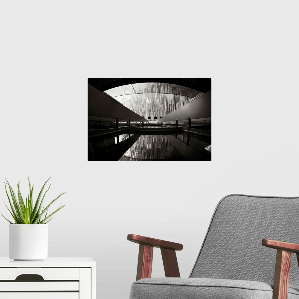 A modern room featuring A black and white photograph of an architectural structure.