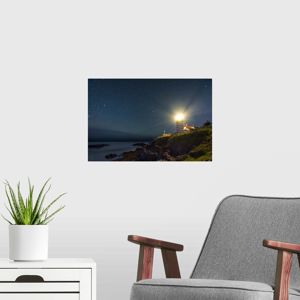 A modern room featuring A photograph of a lighthouse under a starry night sky.