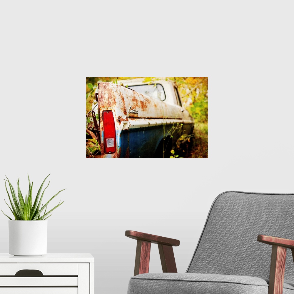 A modern room featuring Photograph of a derelict truck in the woods.