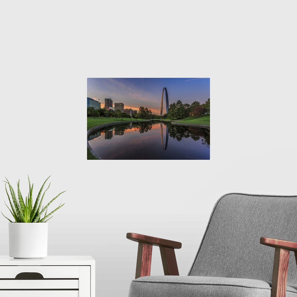 A modern room featuring A photograph of a St. Louis Missouri at sunset.