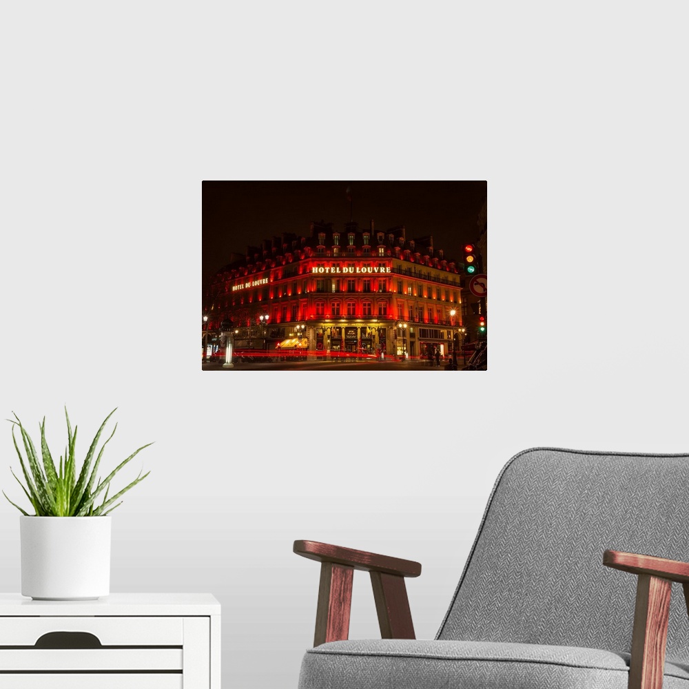 A modern room featuring A photograph of the Hotel du Louvre at night.