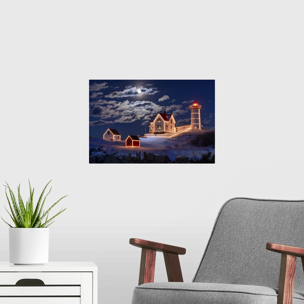A modern room featuring Photograph of a lighthouse and other small building outlined in lights, under a bright moon and c...