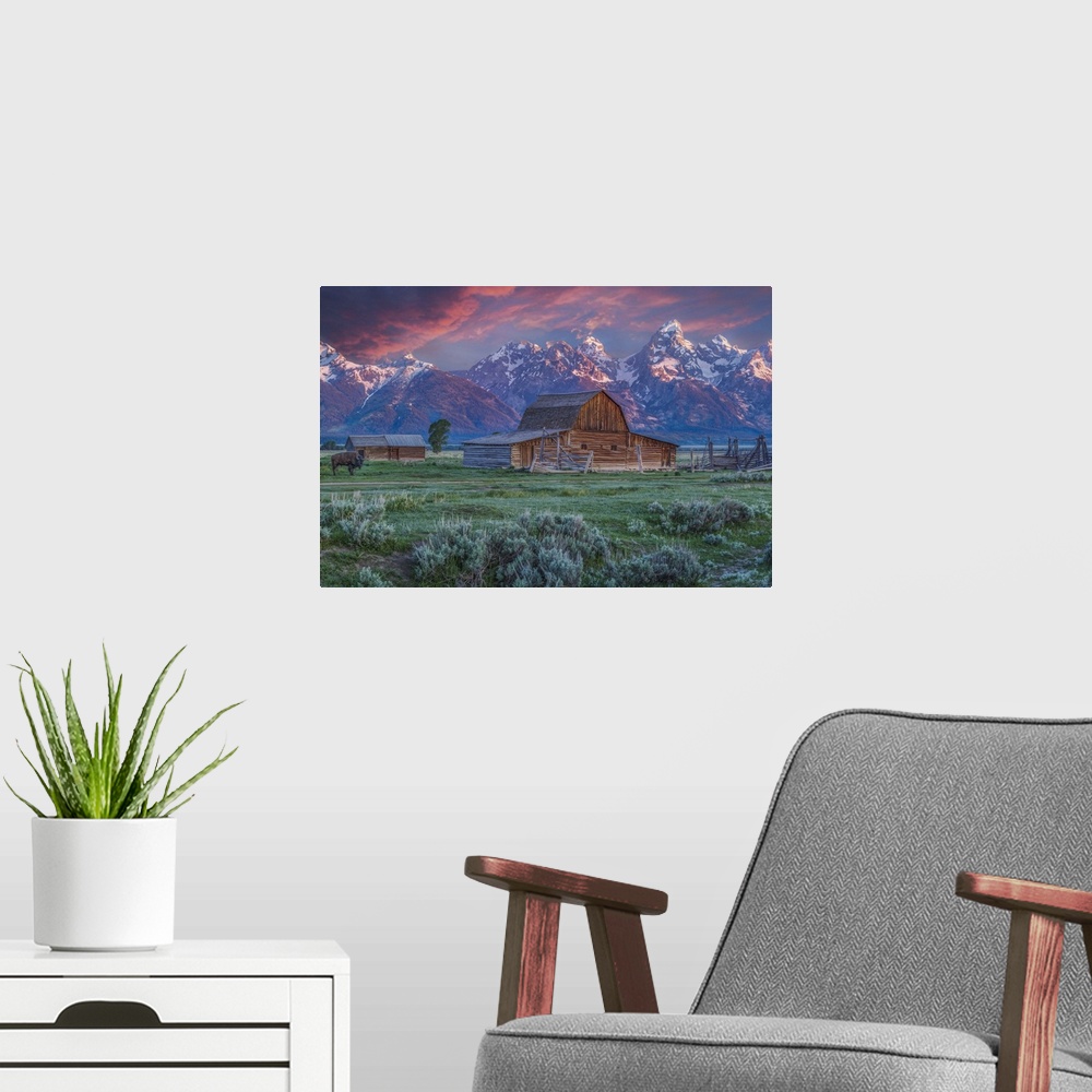 A modern room featuring A photograph of the Mormon Row Barn in Wyoming, with the Teton mountains in the background.
